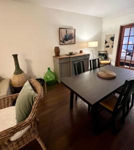 a living room with a dining room table and chairs at Charming Heritage Home with Mountain and City Views in Vancouver