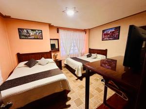 Postel nebo postele na pokoji v ubytování Hotel Monarca Tlalpujahua