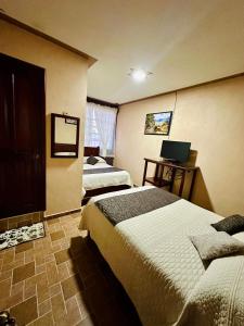 Postel nebo postele na pokoji v ubytování Hotel Monarca Tlalpujahua