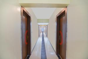 an empty corridor with two doors in a building at Sunshine Inn Near Pune Railway Station in Pune