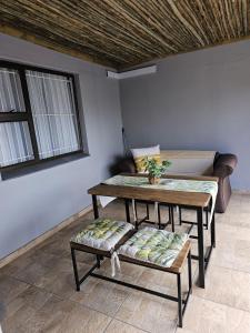 a living room with a table and a couch at Déjàvu at the Bay in Richards Bay