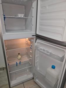 an open refrigerator with a bottle of milk in it at Déjàvu at the Bay in Richards Bay