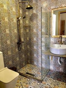 a bathroom with a shower and a toilet and a sink at Sahil Inn Baku Hotel Formula 1 View in Baku