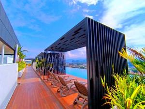 a deck with chairs and a view of the water at The Horizon Ipoh Dual L13 by Grab A Stay in Ipoh