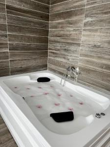 a bath tub with flowers on it in a bathroom at Lion King Hotel in Esenyurt