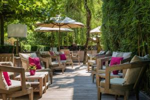 a row of chairs and umbrellas on a patio at Park Hotel Sonnenhof - Relais & Châteaux in Vaduz