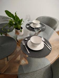 a table with plates and napkins on top of it at Apartament Karoliny 2 self check-in, parking in Rzeszów