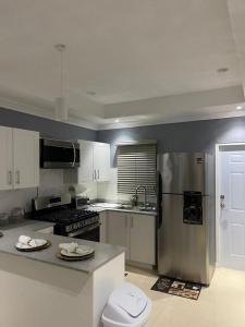 a kitchen with a stainless steel refrigerator at Alexia's Stay in Portmore