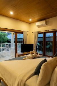 a bedroom with a bed with a stuffed animal on it at Villa Baru 3 Bedroom in Tabanan +50 photos
