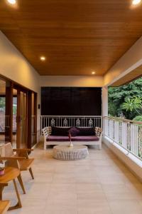 a living room with a couch and a table at Villa Baru 3 Bedroom in Tabanan