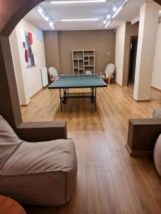 a living room with a ping pong table in it at Villa ChrysPa Attica in Dhílesi