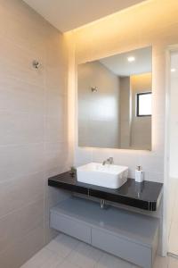 a bathroom with a sink and a mirror at Ayu Homestay in Klang