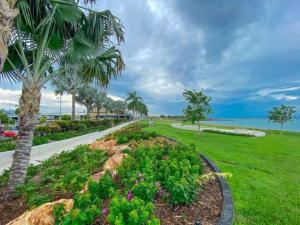 a park with a palm tree and a sidewalk at Spectacular Marina Views Apartment in Larrakeyah