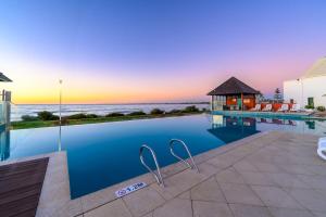 a swimming pool with a view of the ocean at Sea Side 508 in Mandurah