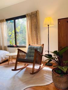 a living room with a chair and a lamp at Elephant's House - Đường Lâm Homestay in Hanoi