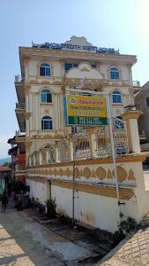 a building with a sign in front of it at Phongpadith in Khoa