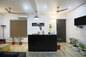 a man standing at a podium in an office at Townhouse Cloud Bay, Near Genpact, Sector-69, Gurgaon in Gurgaon