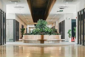 a lobby with a large planter with plants in it at Armin Homes 2 Bedroom apartment at Ecopark in Kim Quan