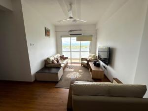 a living room with a couch and a tv at Rush Resident Mount Lavinia in Mount Lavinia