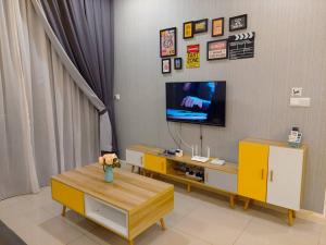 a living room with a tv and a yellow cabinet at Walk to Legoland * D'Pristine * 2BR Pool View #7 in Nusajaya