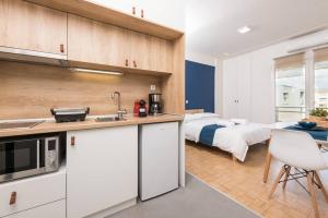 cocina y dormitorio con cama de fondo en Pantheon square view 3, en Komotiní
