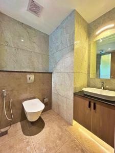 a bathroom with a sink and a toilet in it at VAGA NAKSHATHRA SUITES in Vagamon