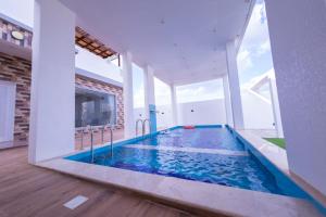 a swimming pool in the middle of a house at بهجة الجبل الأخضر in Ḩayl Yaman