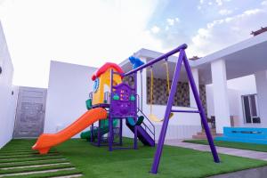 a playground in a house with a slide at بهجة الجبل الأخضر in Ḩayl Yaman