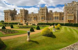 a large castle with a lawn in front of it at THE ROYAL BOUTIQUE OXFORD LODGE by LONDON SLEEP 6 in Hayes