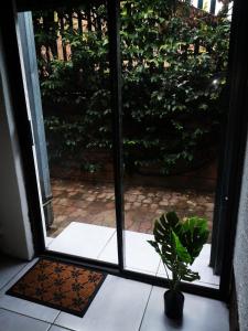an open door with a potted plant in front of it at Be Our Guest Near OR TAMBO International Airport in Boksburg