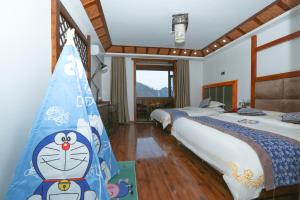 a bedroom with three beds with a cat sign on the wall at Mountainside in Zhangjiajie