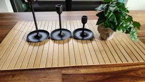 a wooden table with three spoons on top of it at Comfy 2 bed appt in central werribee in Werribee