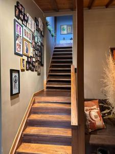 a staircase in a house with pictures on the wall at Cabaña sendero verde in Envigado