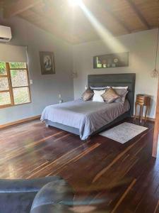 een slaapkamer met een bed met kussens erop bij Cabaña sendero verde in Envigado