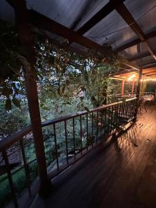 a porch with a bench on a wooden deck at Cabaña sendero verde in Envigado