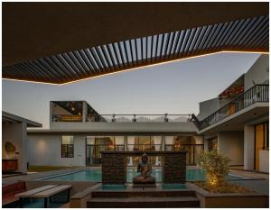 an external view of a house with a swimming pool at Casa Concreto-Infinite Luxury in Jodhpur