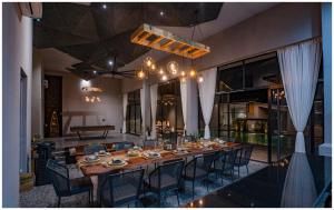 a dining room with a long table and chairs at Casa Concreto-Infinite Luxury in Jodhpur