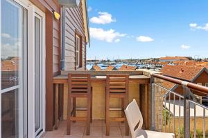 a balcony with two chairs and a table with a view at Nautica Residences Hillarys in Perth