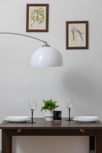 a table with two glasses and a lamp on it at Minimalist One Bedroom Apartment in Kraków Near Wawel by Renters in Krakow