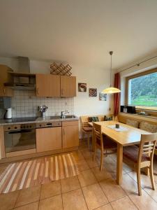 a kitchen with a table and a dining room at Haus Harbauer in Neustift im Stubaital