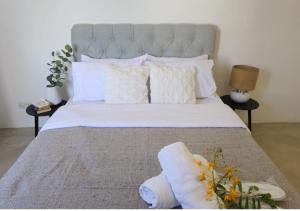 a bedroom with a large bed with white sheets and pillows at Modern Villa in Grand Bay - Short Walk to Beach in Grand-Baie