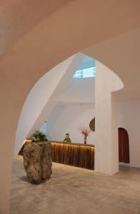 a large rock sits in the middle of a lobby at Green World Hotel Nha Trang in Nha Trang