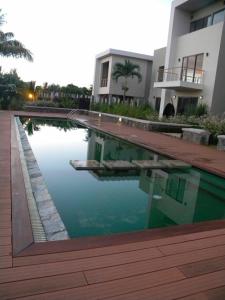 a swimming pool in front of a building at Modern Villa in Grand Bay - Short Walk to Beach in Grand-Baie