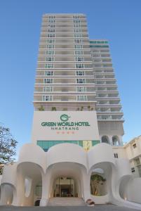 a tall white building with a sign in front of it at Green World Hotel Nha Trang in Nha Trang