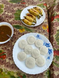 two plates of food with bananas and a bowl of soup at Marari Sunset Beach Villa in Alleppey