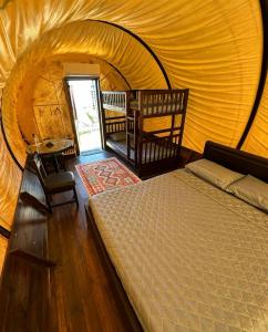 a bedroom with a bed in a tent at Panorama Glamping in Tân Phú