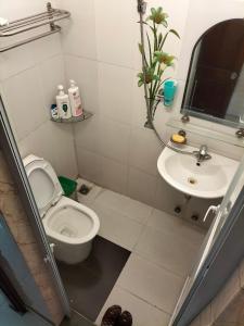 a bathroom with a toilet and a sink at Roma Hotel Noi Bai airport in Hanoi