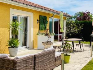 a patio with chairs and a table and an umbrella at lamaison-d'ose in Romans