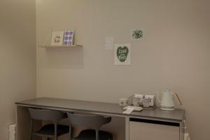 a desk in a room with two chairs in a room at Stay Dooroo in Suncheon