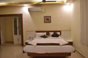 une chambre avec deux lits et un ventilateur de plafond dans l'établissement SEA LUXE Beach Resort, à Dapoli 14 autres photos